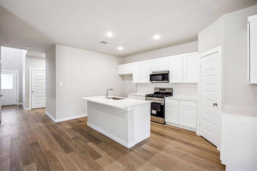 Kitchen in the Willow home plan by Trophy Signature Homes – REPRESENTATIVE PHOTO