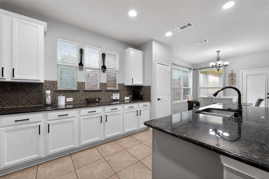 2760 Explorador, Grand Prairie, TX 75054 Kitchen featuring white cabinetry, dark stone countertops, and a mosaic tile backsplash