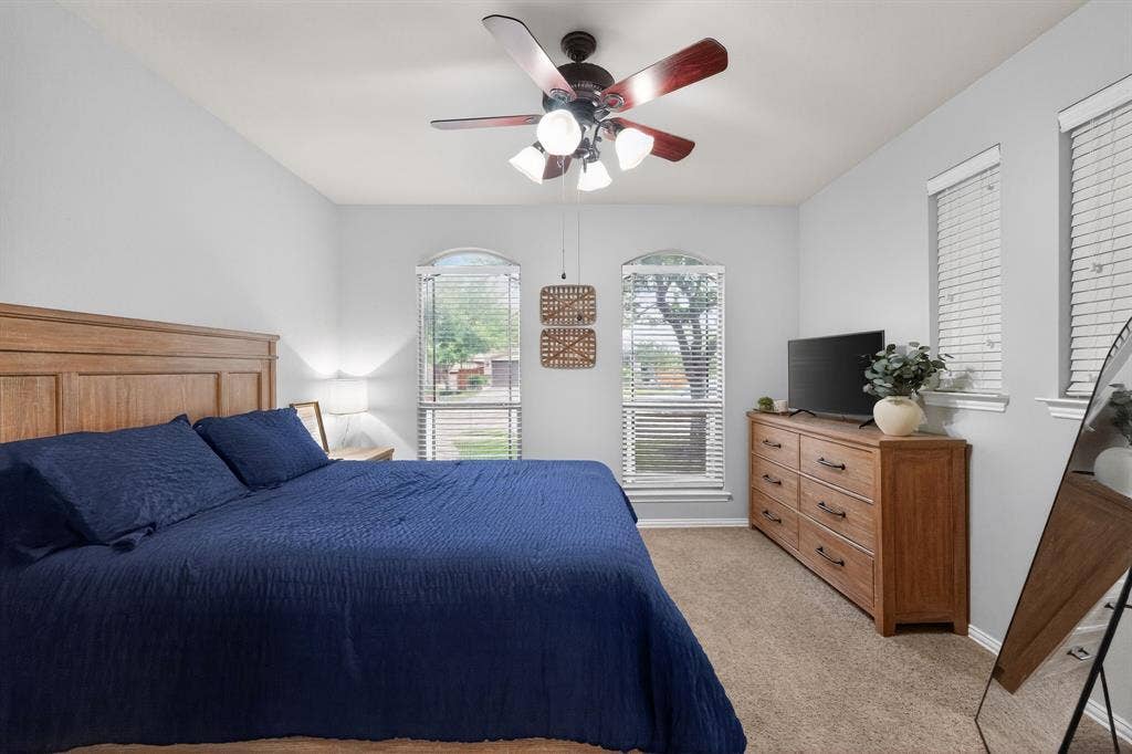 2760 Explorador, Grand Prairie, TX 75054 Downstairs -Bedroom #2 with vaulted ceiling, arched window, and a ceiling fan with integrated lighting