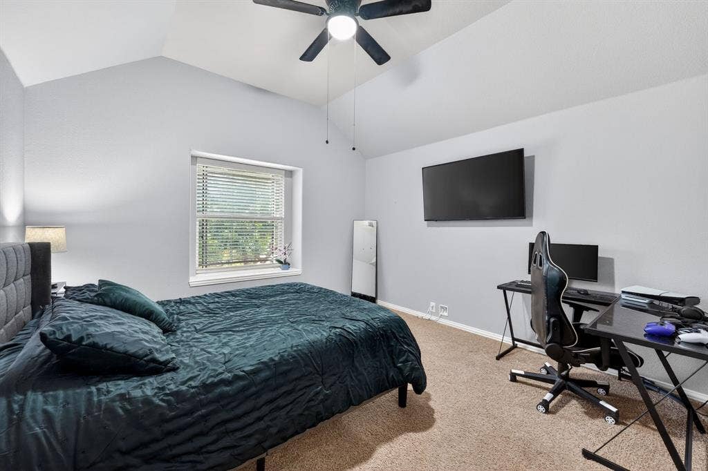 2760 Explorador, Grand Prairie, TX 75054 Upstairs - Bedroom # 5 Spacious room featuring vaulted ceilings, a ceiling fan with integrated lighting, a large window with blinds, and neutral-toned carpeting