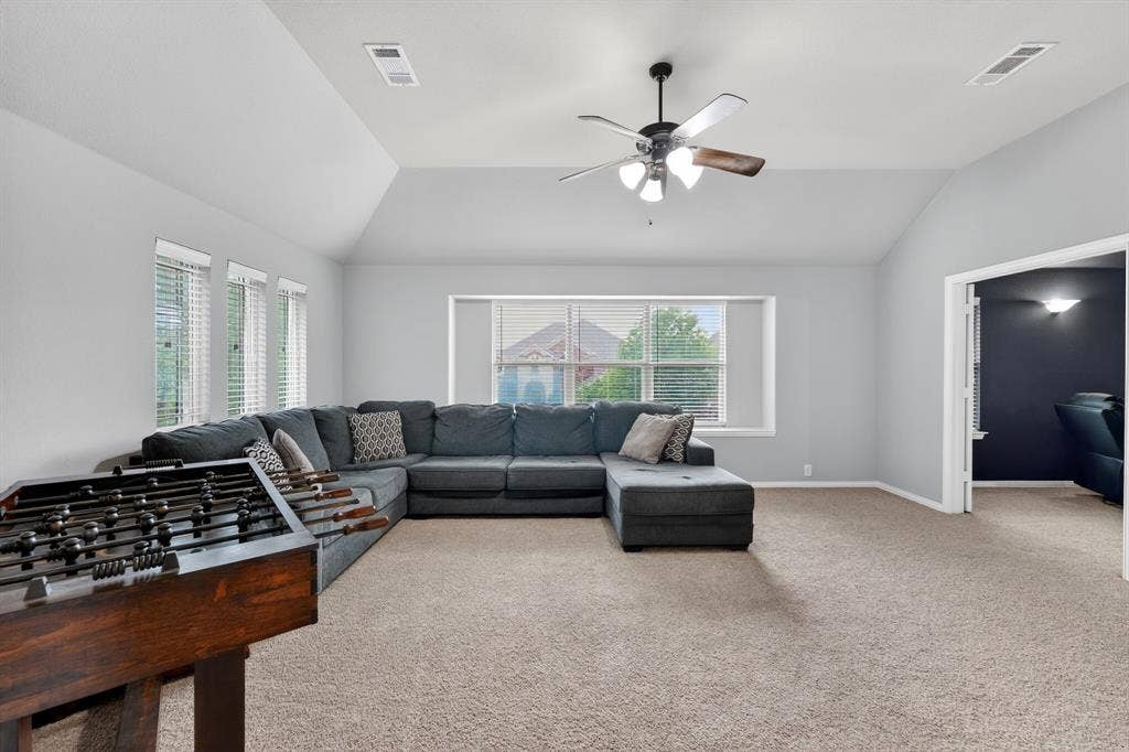 2760 Explorador, Grand Prairie, TX 75054 Upstairs spacious room featuring vaulted ceilings, a ceiling fan with light fixture, multiple windows with blinds, and carpet flooring