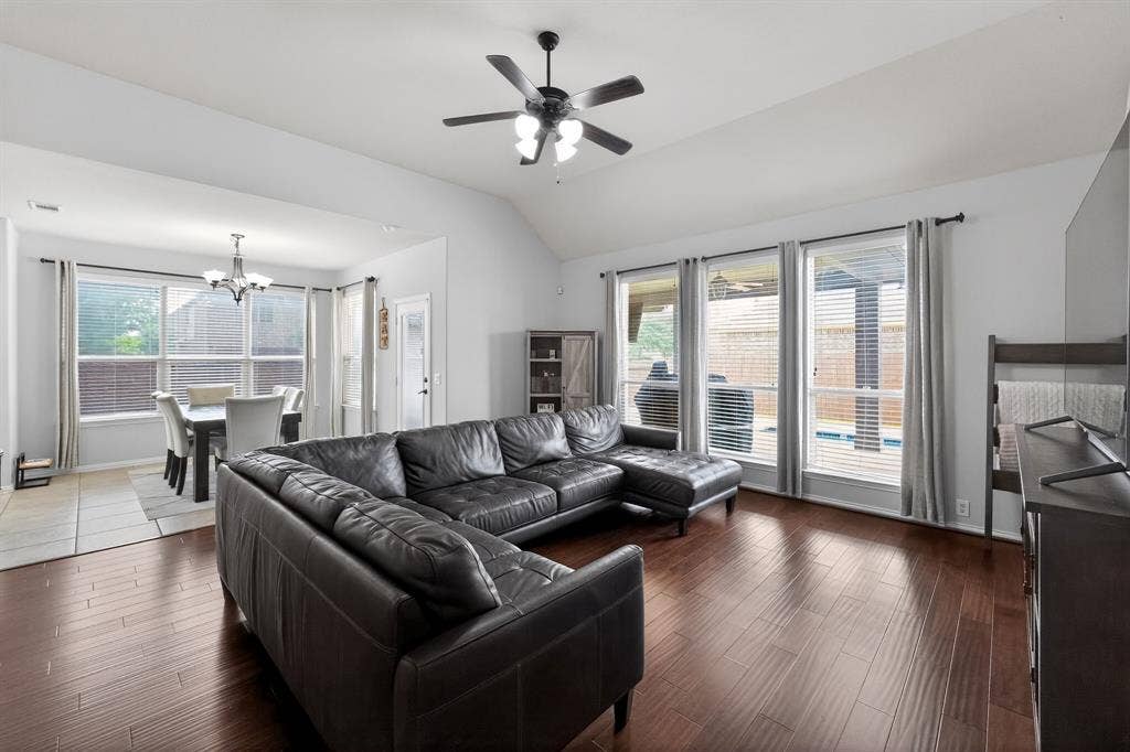 2760 Explorador, Grand Prairie, TX 75054 Spacious living area featuring wood-finish flooring, a vaulted ceiling, and an overhead ceiling fan