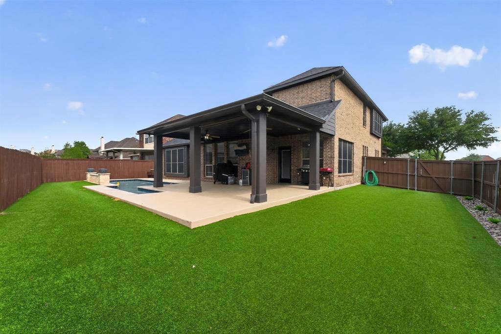 2760 Explorador, Grand Prairie, TX 75054 Expansive turf lawn with a covered patio and swimming pool.