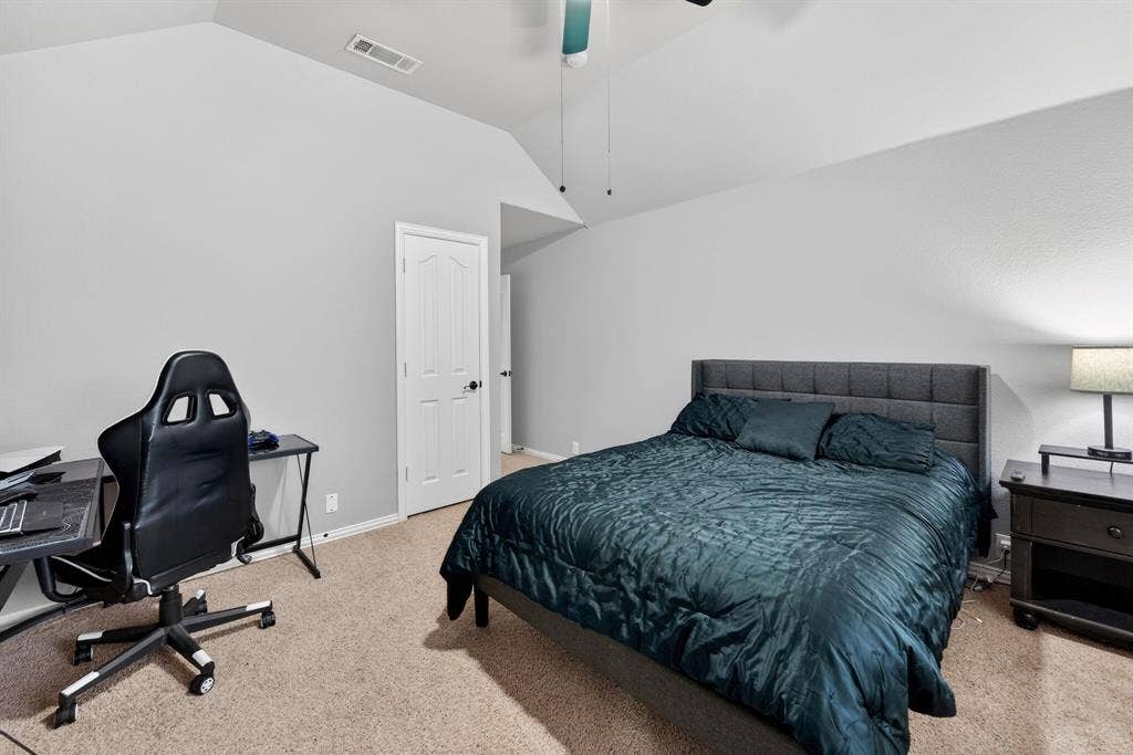 2760 Explorador, Grand Prairie, TX 75054 Upstairs - Bedroom # 5 featuring a textured carpet floor, vaulted ceiling, ceiling fan and walk in closet.