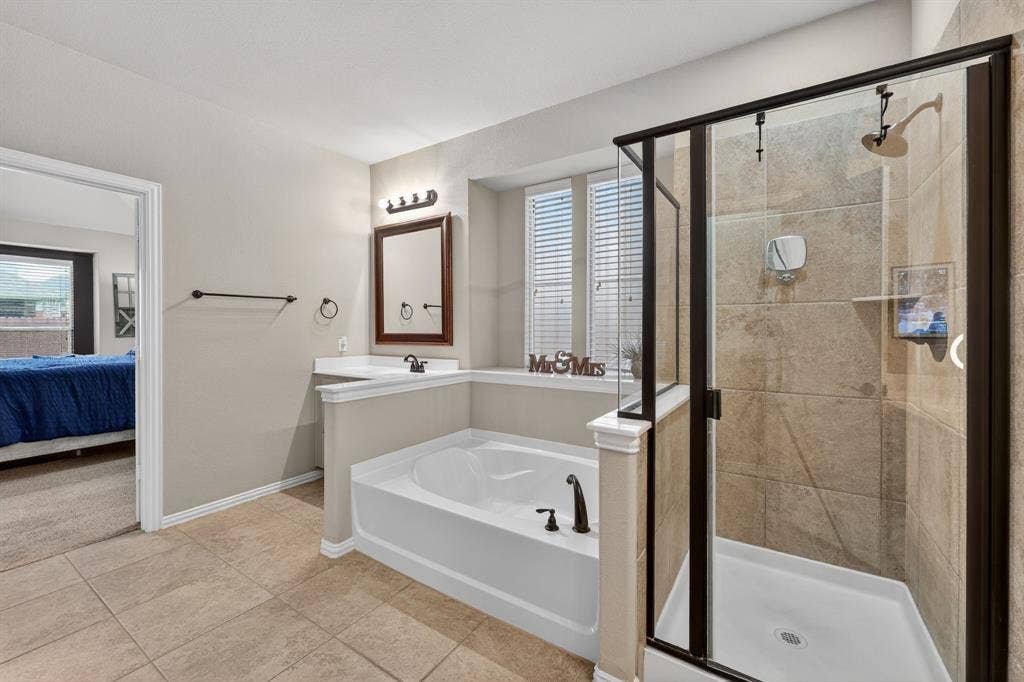 2760 Explorador, Grand Prairie, TX 75054 Bathroom featuring a walk-in shower with tile surround, built-in tub, single vanity with countertop, and tile flooring