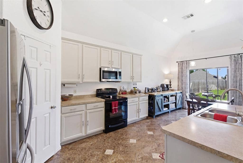 1081 Barrington Drive, Prosper, TX 75078 Kitchen featuring light-finish cabinetry, built-in microwave, electric cooktop, and dual basin sink