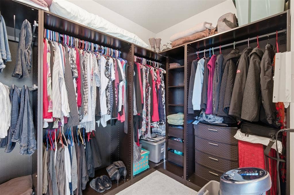 1081 Barrington Drive, Prosper, TX 75078 Custom closet system featuring, extensive hanging rods, multiple shelving units, and integrated drawers