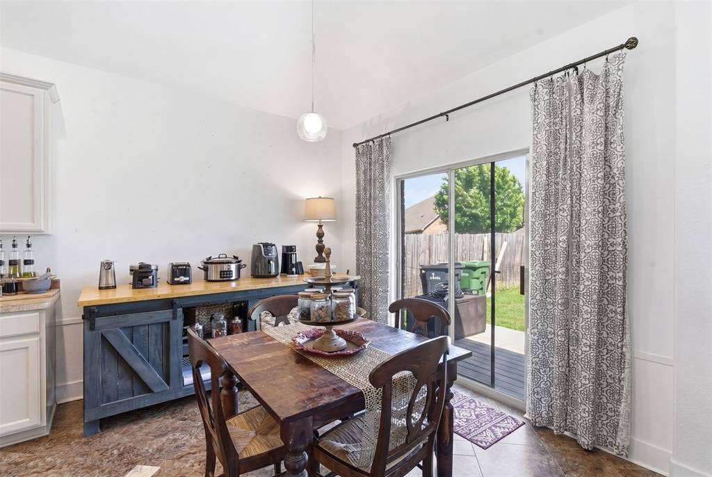 1081 Barrington Drive, Prosper, TX 75078 Dining area featuring a decorative pendant light, and sliding glass doors leading to a fenced backyard