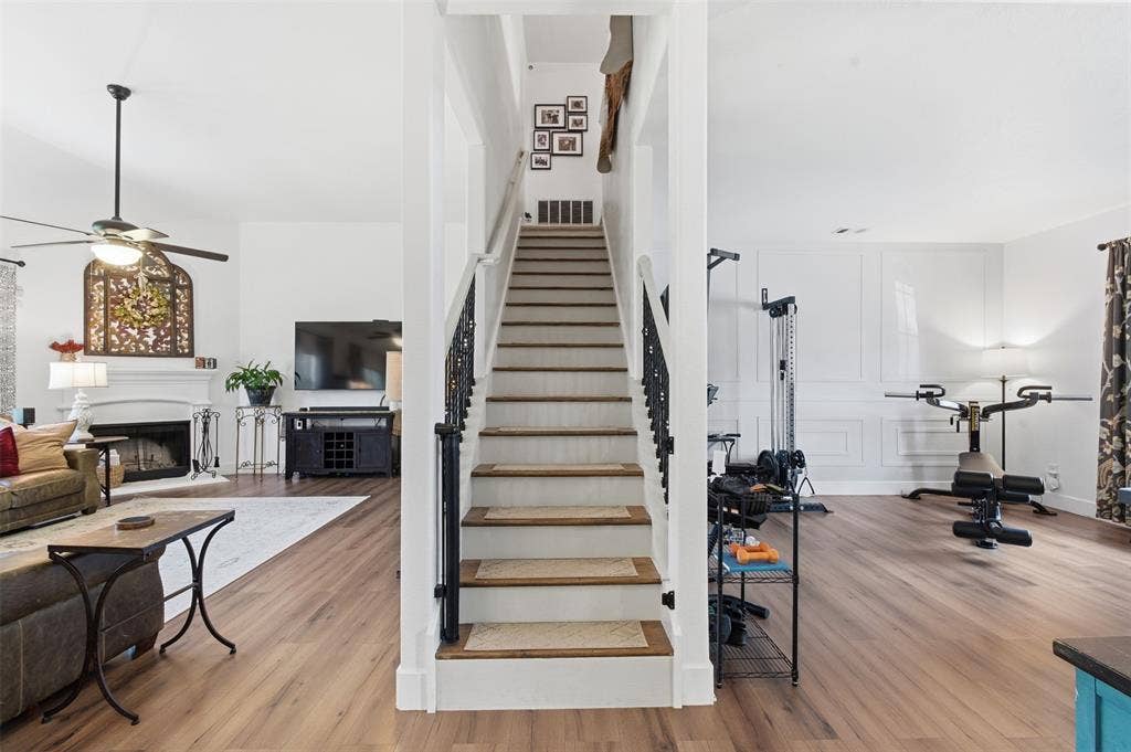 1081 Barrington Drive, Prosper, TX 75078 Central staircase with dark metal balusters and wood-finish treads