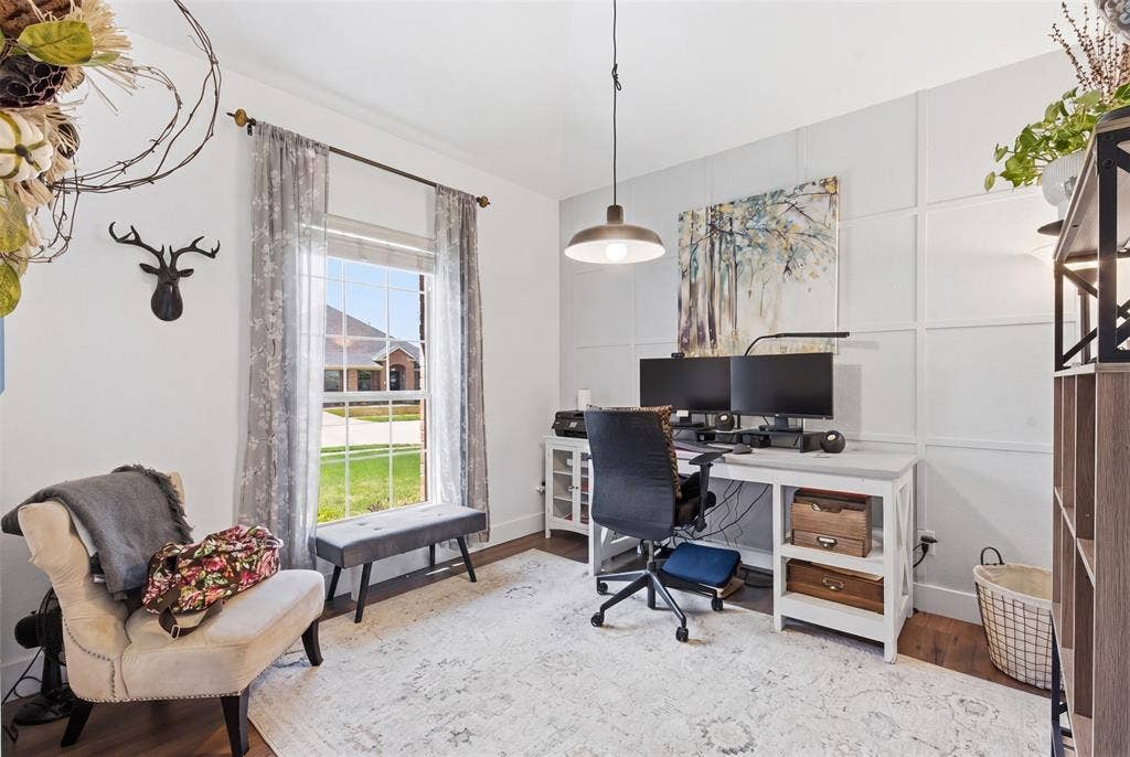 1081 Barrington Drive, Prosper, TX 75078 Versatile room featuring a large window, decorative wall paneling, a ceiling-mounted light fixture, and wood-finish flooring