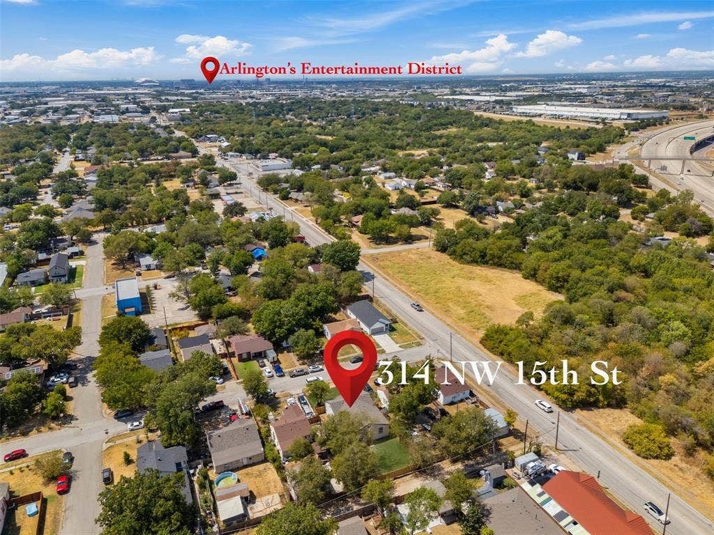 314 NW 15th Street, Grand Prairie, TX 75050 Aerial perspective of a residential neighborhood with mature trees and visible access to a multi-lane highway