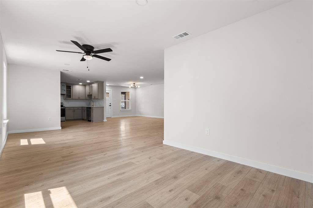 314 NW 15th Street, Grand Prairie, TX 75050 Expansive room with light wood-finish flooring, recessed lighting, and a ceiling fan