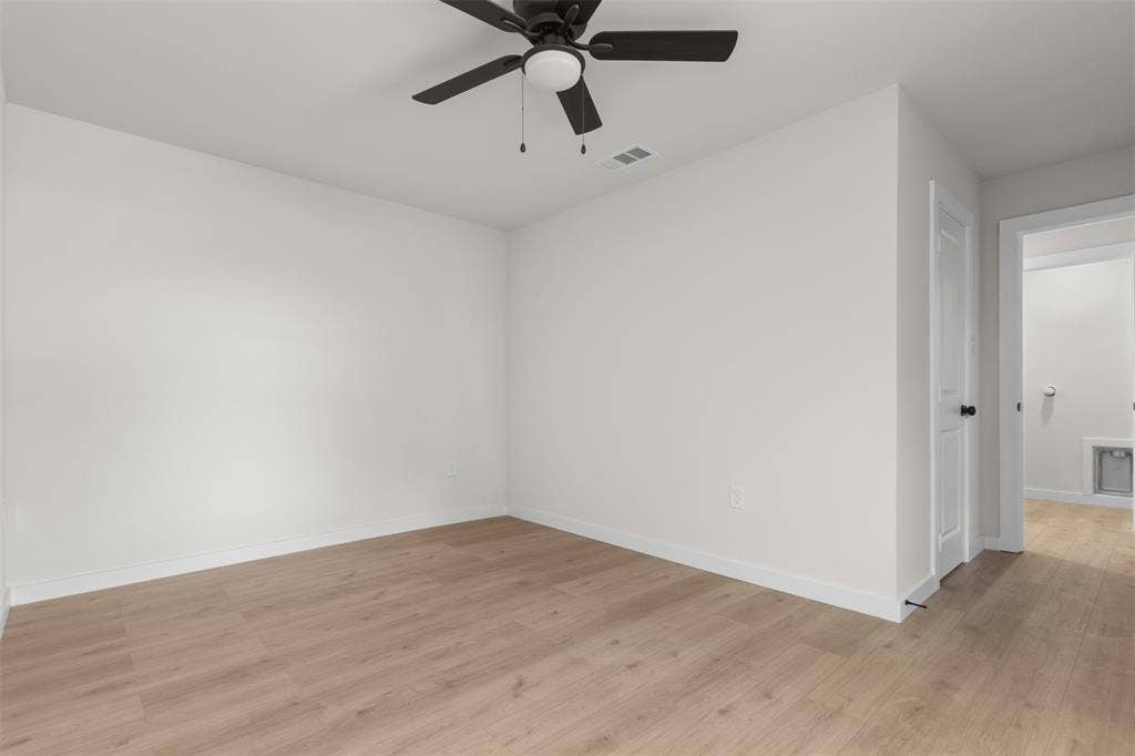 314 NW 15th Street, Grand Prairie, TX 75050 Wood-finish flooring, white walls, and a ceiling fan with light fixture