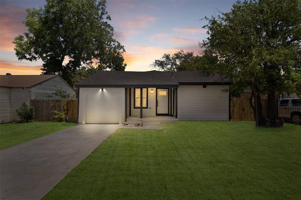 314 NW 15th Street, Grand Prairie, TX 75050 Contemporary single-story residence with a dark asphalt shingle roof, light-colored siding, and a concrete driveway