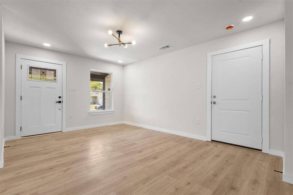 314 NW 15th Street, Grand Prairie, TX 75050 Wood-finish flooring, white walls, recessed lighting, and a modern ceiling fixture