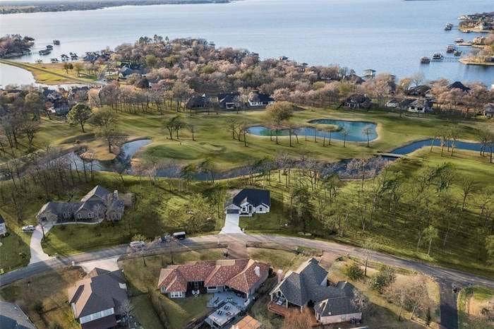 203 Saint Andrews Drive, Mabank, TX 75156 Aerial perspective showcasing a golf course setting and a substantial body of water