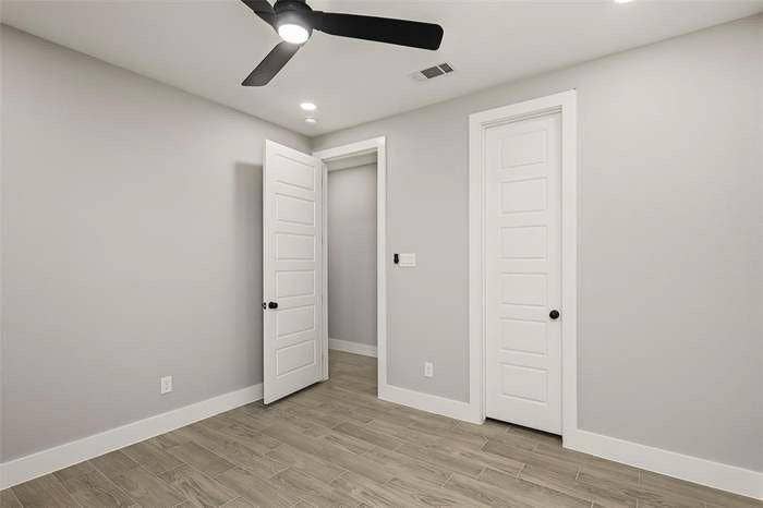 203 Saint Andrews Drive, Mabank, TX 75156 Room featuring light gray walls, wood-finish flooring, a contemporary ceiling fan, recessed lighting, and white interior doors with black hardware