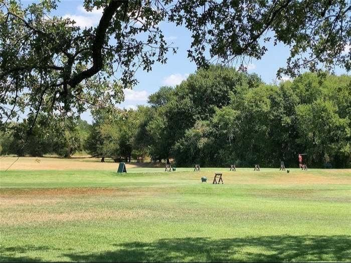 203 Saint Andrews Drive, Mabank, TX 75156 Expansive green space featuring a large tree canopy in the foreground and a tree line in the background