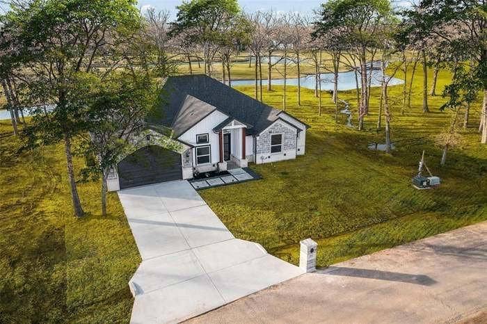 203 Saint Andrews Drive, Mabank, TX 75156 Modern farmhouse architecture with white siding and stone accents
