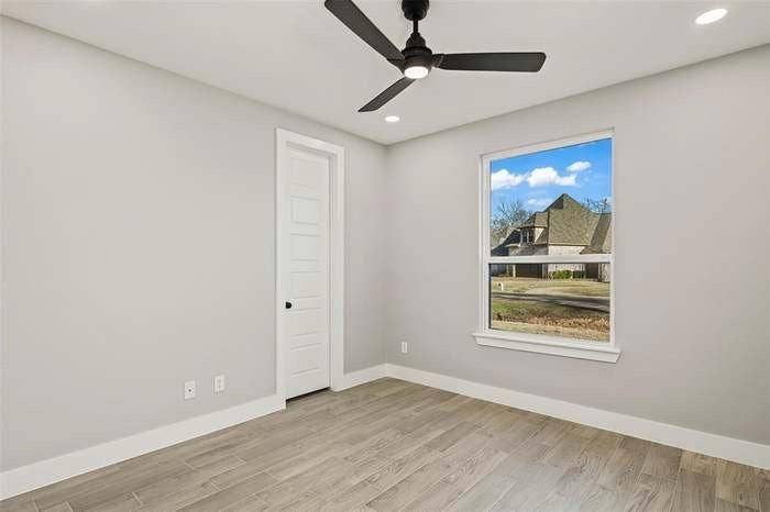 203 Saint Andrews Drive, Mabank, TX 75156 Room featuring wood-finish flooring, light gray walls, and white trim
