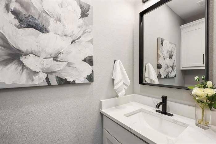 203 Saint Andrews Drive, Mabank, TX 75156 White vanity with an integrated rectangular sink, matte black single-handle faucet, and white countertop