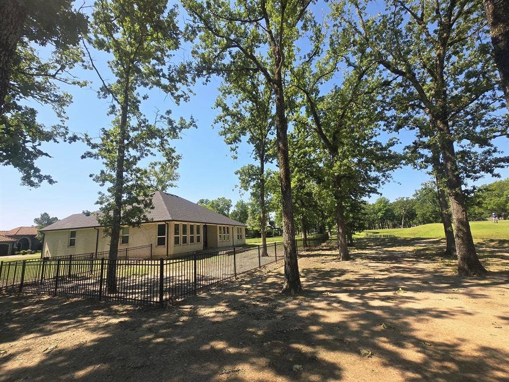 203 Saint Andrews Drive, Mabank, TX 75156 Expansive green lawn surrounds the rear of the property
