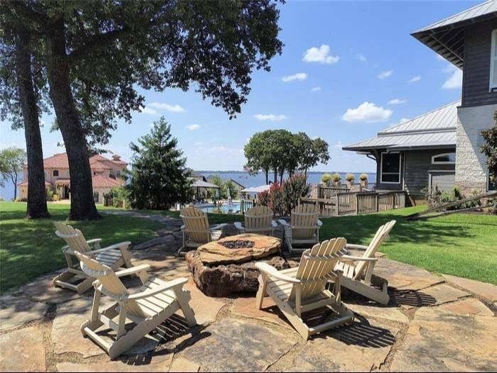 203 Saint Andrews Drive, Mabank, TX 75156 Expansive stone patio featuring a built-in fire pit