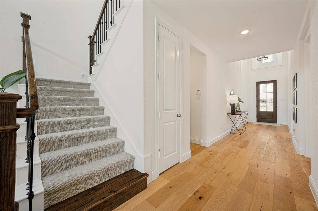 961 Gladewater Drive, Prosper, TX 75078 The entry way is a light and bright first impression as the open hallway and natural flooring offer a warm and welcoming first impression