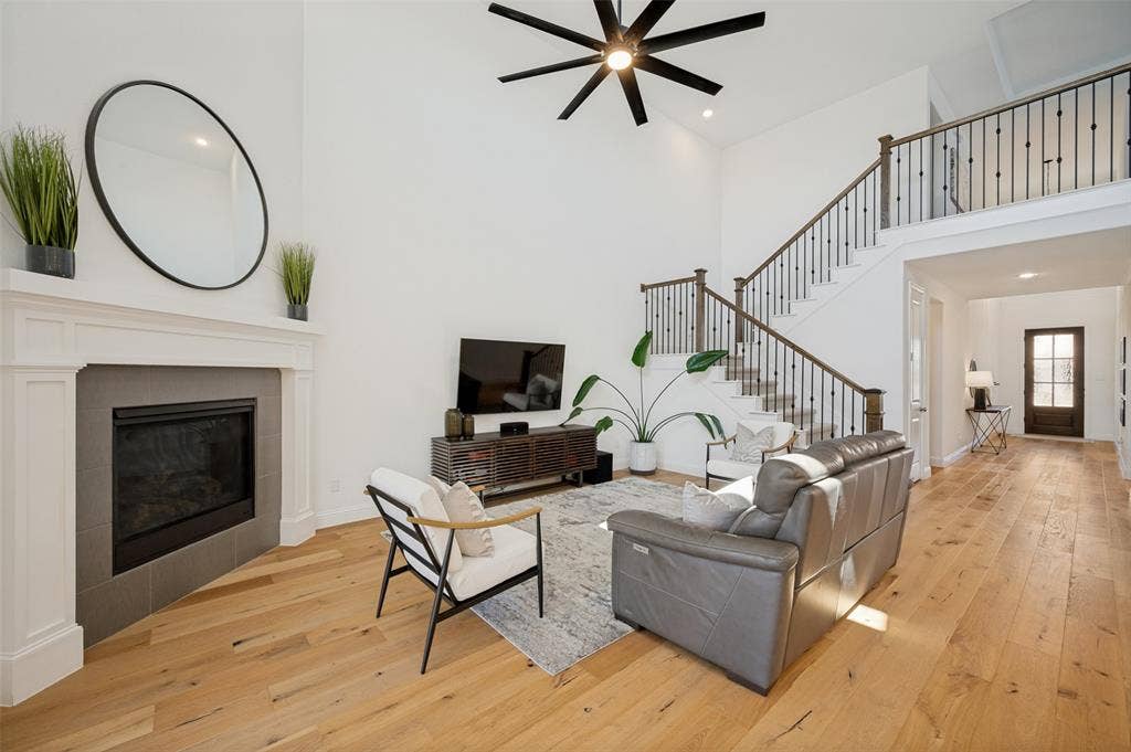 961 Gladewater Drive, Prosper, TX 75078 These light interior features combined with light wood flooring are a mix of warmth and modern with a fireplace as a seasonal focal point