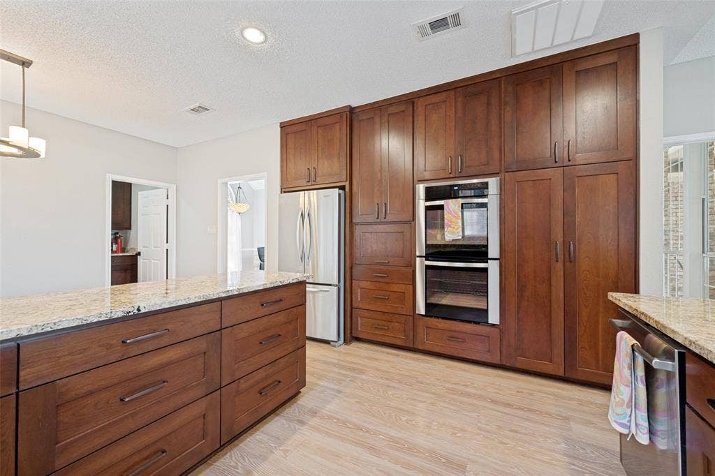 1818 Haydenbend Circle, Grapevine, TX 76051 Kitchen with double ovens, wall of cabinets