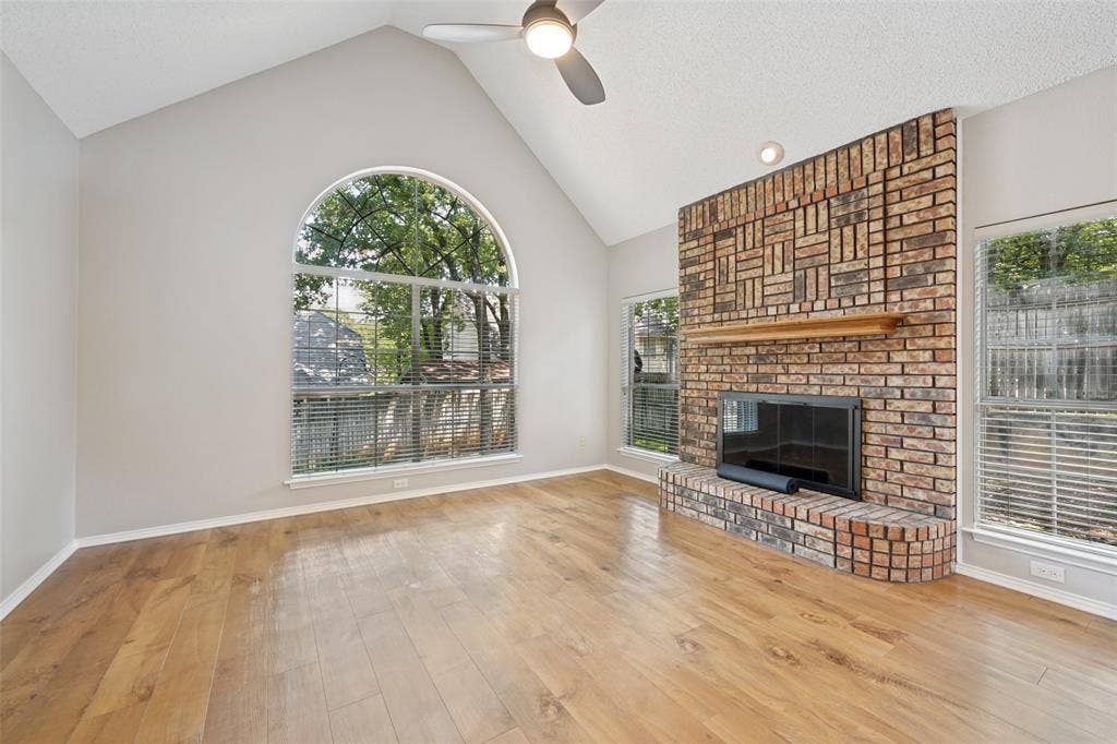 1818 Haydenbend Circle, Grapevine, TX 76051 Living room with wood like floor and stone fireplace