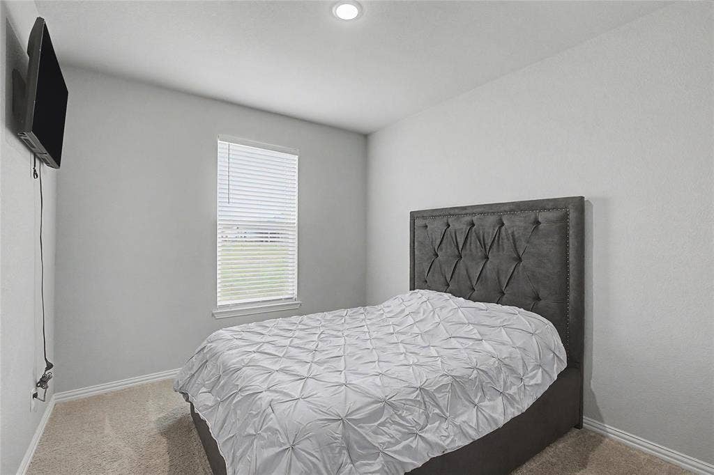 185 Chester Road, Springtown, TX 76082 Neutral-toned room featuring a single window with blinds, recessed ceiling lighting, and carpeted flooring