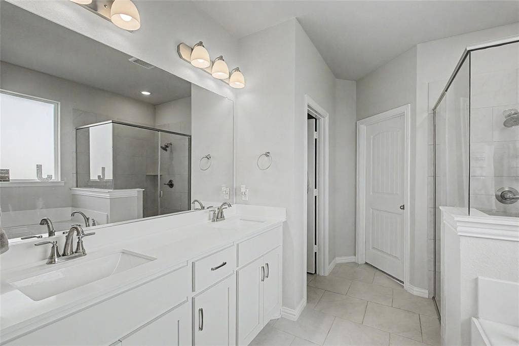 185 Chester Road, Springtown, TX 76082 Dual vanity with integrated sinks, brushed nickel fixtures, and ample counter space