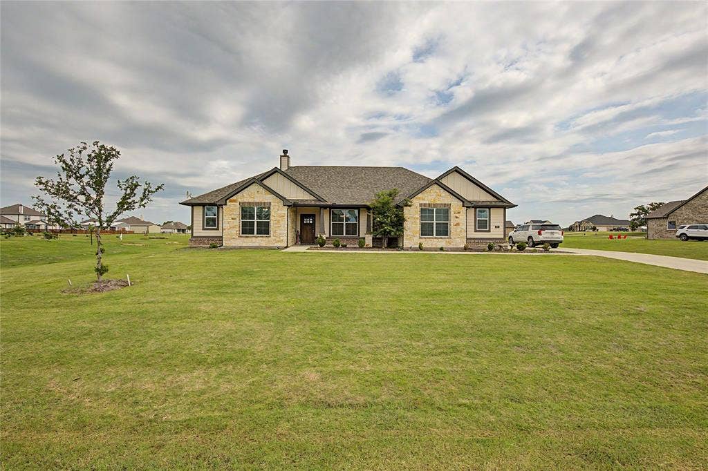 185 Chester Road, Springtown, TX 76082 Ranch-style residence featuring a stone and siding facade, a gabled roofline, and a prominent front entry