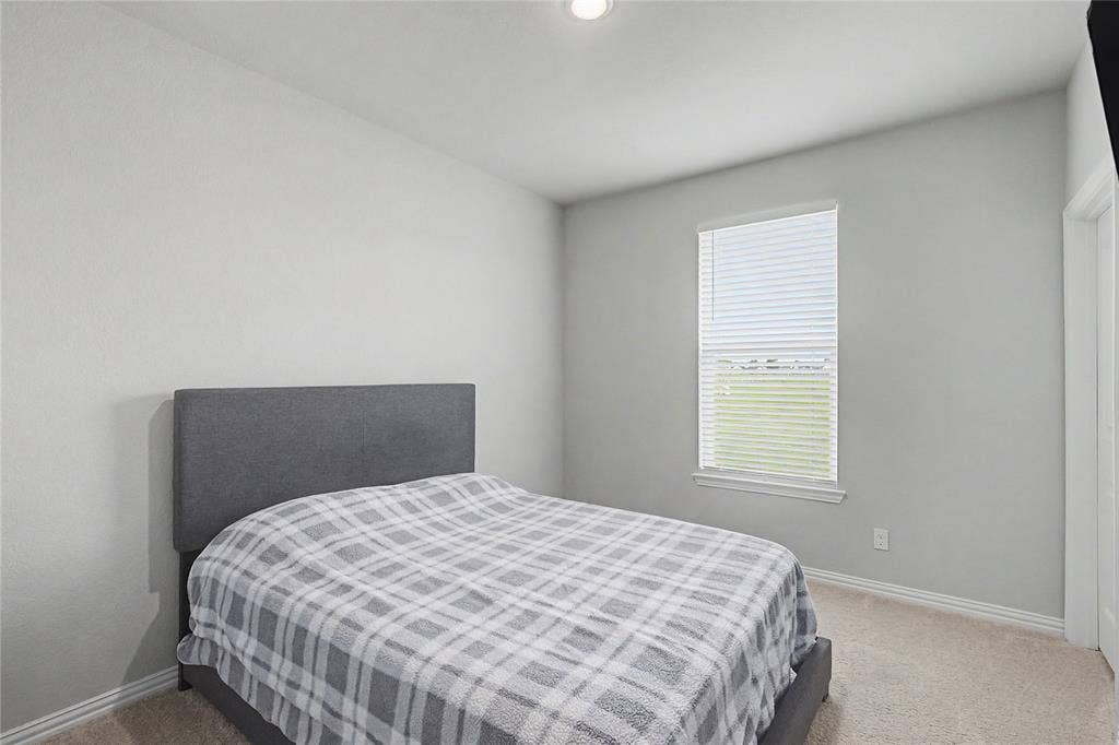185 Chester Road, Springtown, TX 76082 Carpeted room featuring a single window with blinds, light gray walls, and white baseboards