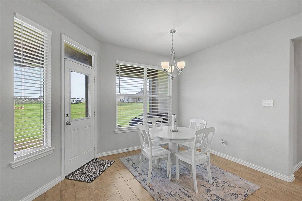 185 Chester Road, Springtown, TX 76082 Dining area featuring wood-finish flooring and a contemporary chandelier