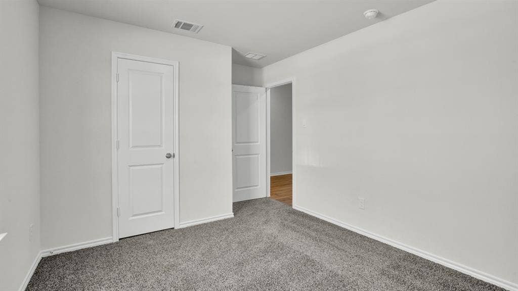 200 Bandit Trail, Terrell, TX 75160 Carpeted interior space featuring light gray walls, white trim, and a paneled white door