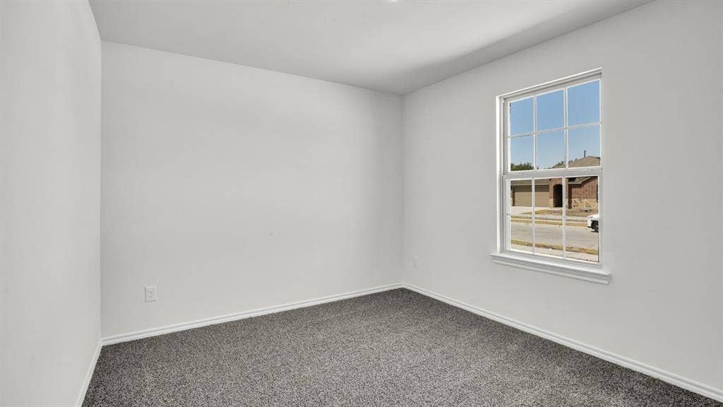 200 Bandit Trail, Terrell, TX 75160 Neutral interior with white walls, gray carpet, and a large window providing ample natural light
