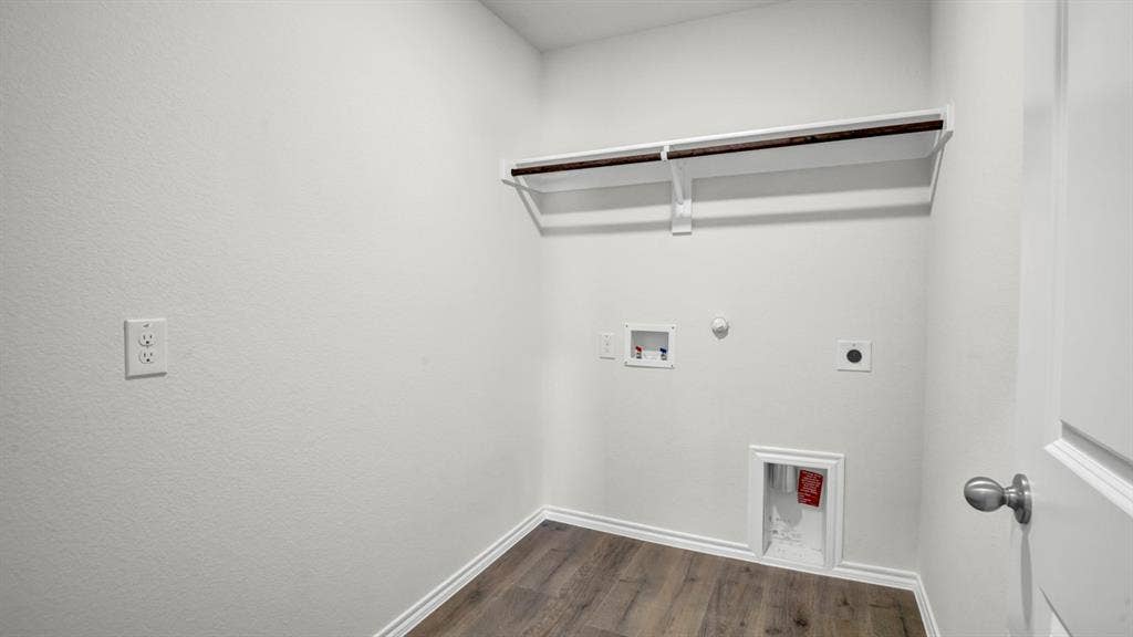 200 Bandit Trail, Terrell, TX 75160 Dedicated laundry area featuring wood-finish flooring, white baseboards, and a clothing rod with shelving