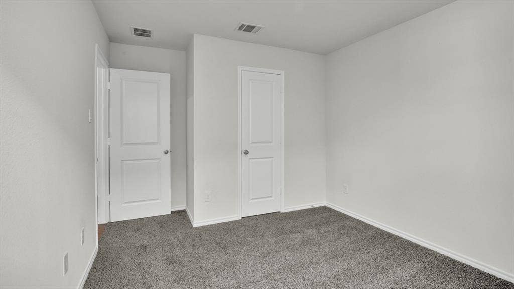 200 Bandit Trail, Terrell, TX 75160 Neutral-toned room featuring a gray carpeted floor, white walls, and white trim