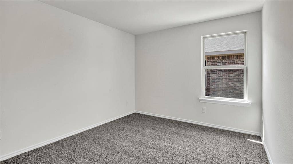200 Bandit Trail, Terrell, TX 75160 Room featuring plush grey carpeting, white painted walls, white trim, and a white-framed window