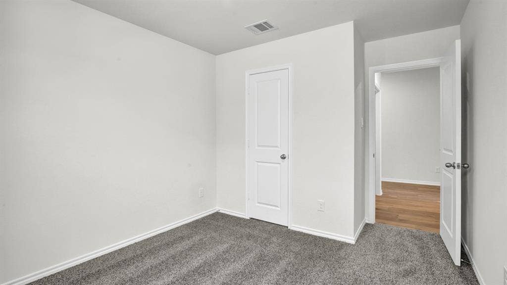 200 Bandit Trail, Terrell, TX 75160 Carpeted room featuring white walls, white trim, and a white paneled door with a silver-tone knob