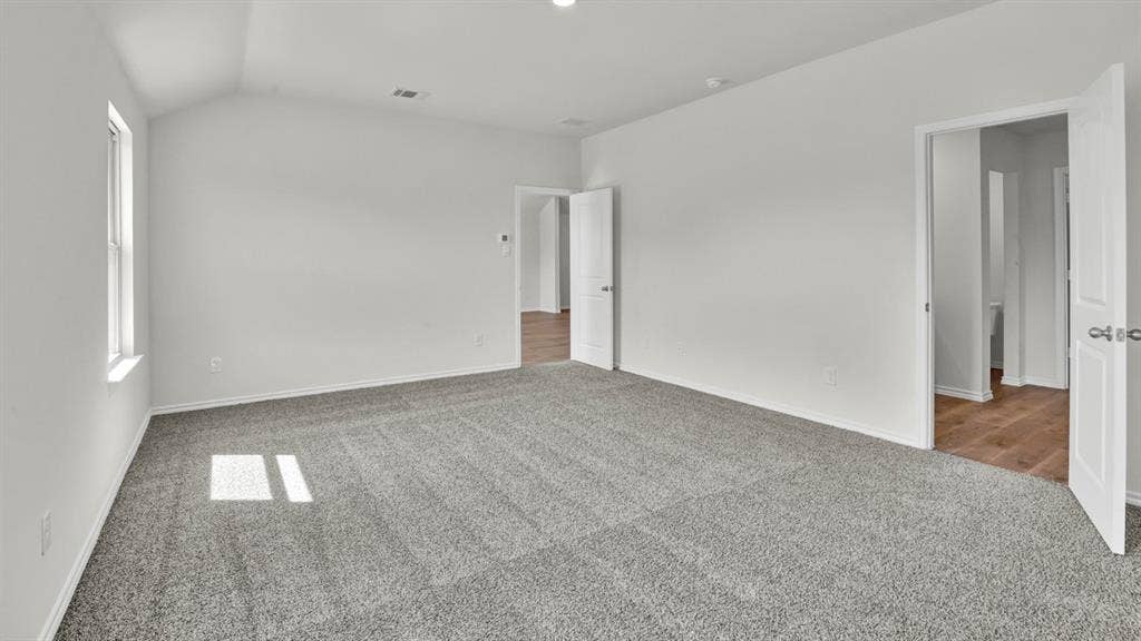 200 Bandit Trail, Terrell, TX 75160 Spacious room featuring vaulted ceilings, light gray carpeting, and white walls
