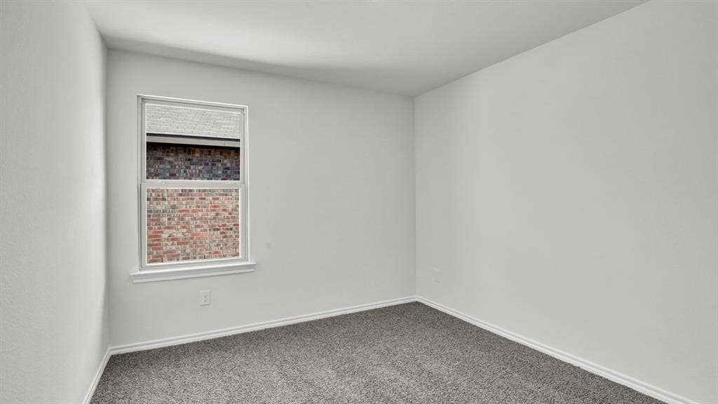 200 Bandit Trail, Terrell, TX 75160 Neutral-toned room featuring a single window with white trim, light gray textured carpeting, and bright white walls