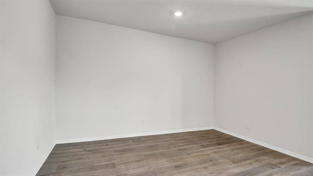 200 Bandit Trail, Terrell, TX 75160 Interior room featuring light-toned walls, wood-finish flooring, recessed lighting, and white baseboards