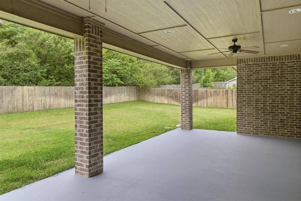 7765 Hickory Spring Lane, Tyler, TX 75703 Covered patio featuring a painted concrete surface, brick columns, and a matching brick accent wall
