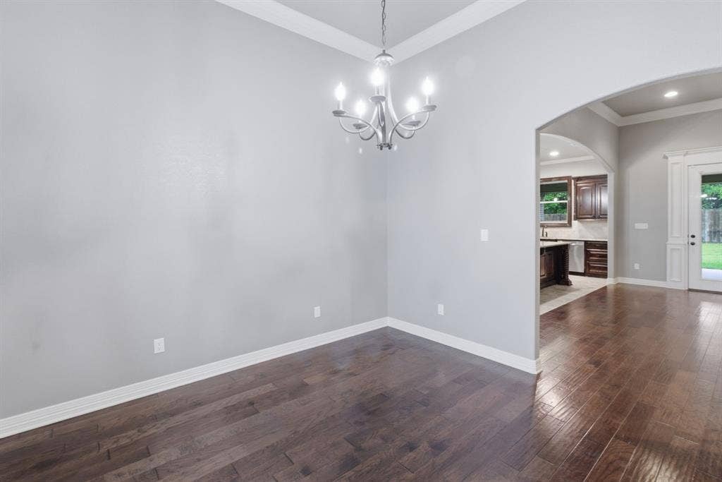 7765 Hickory Spring Lane, Tyler, TX 75703 Spacious interior with wood-finish flooring, light gray walls, and white crown molding