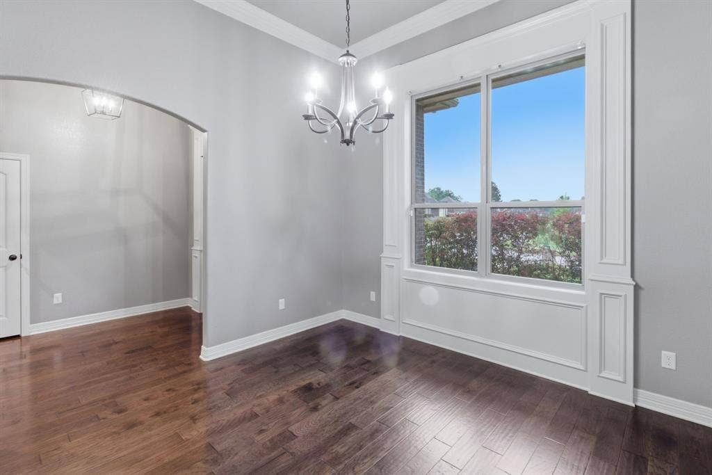 7765 Hickory Spring Lane, Tyler, TX 75703 Hardwood-style flooring throughout this room featuring a prominent window with extensive white trim and wainscoting