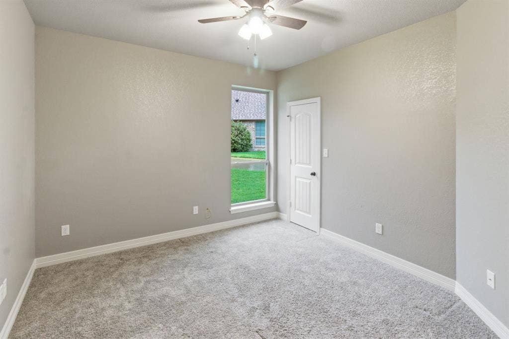7765 Hickory Spring Lane, Tyler, TX 75703 Spacious room featuring neutral carpeting, light gray wall paint, and white trim