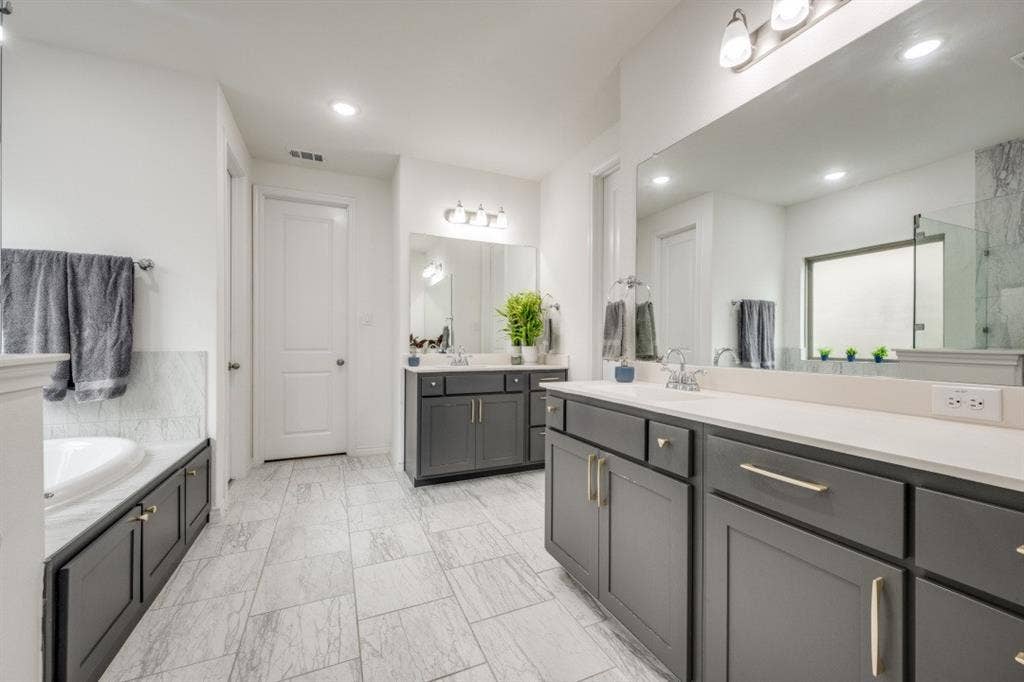2813 Walker Way, Northlake, TX 76247 Contemporary bathroom featuring dual dark wood vanities with light countertops, undermount sinks, and chrome faucets